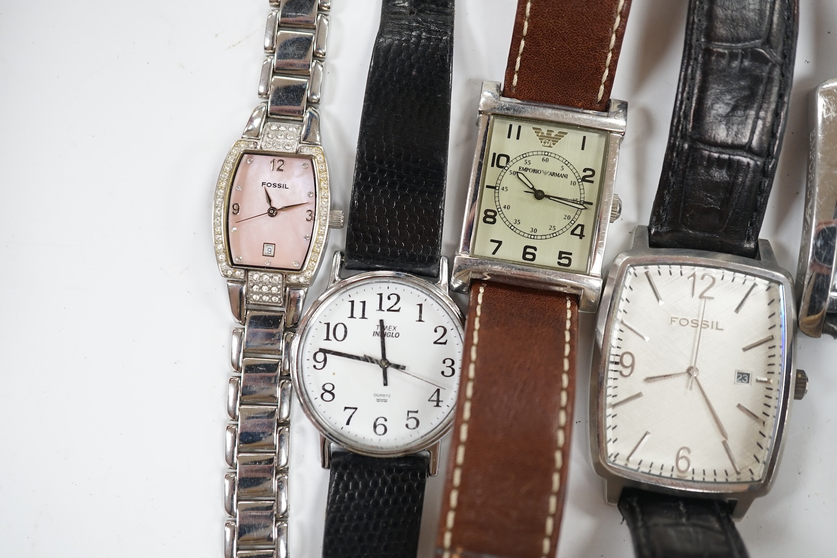 Eight assorted lady's and gentleman's modern wrist watches including Emporio Armani, Esq and Fossil. Condition - poor to fair